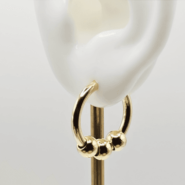 Goudkleurige hoops met 3 bolletjes in oor